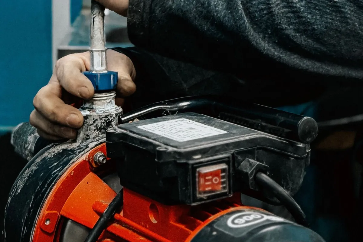 A technician setting up a water pump indoors